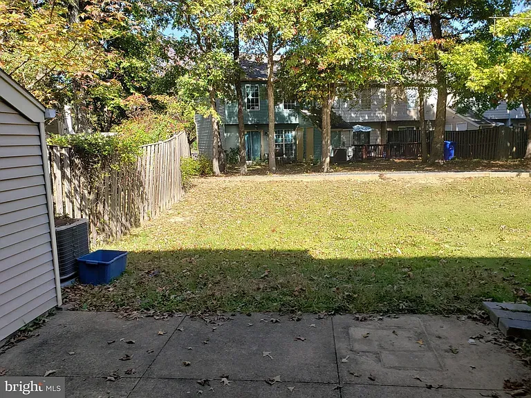 Patio and fenced backyard behind the townhome