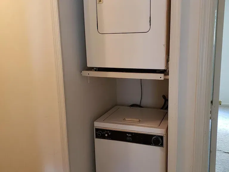 Stacked washer and dryer in a hallway closet