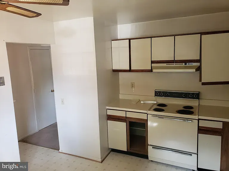 Kitchen with upper and lower cabinets and an electric range