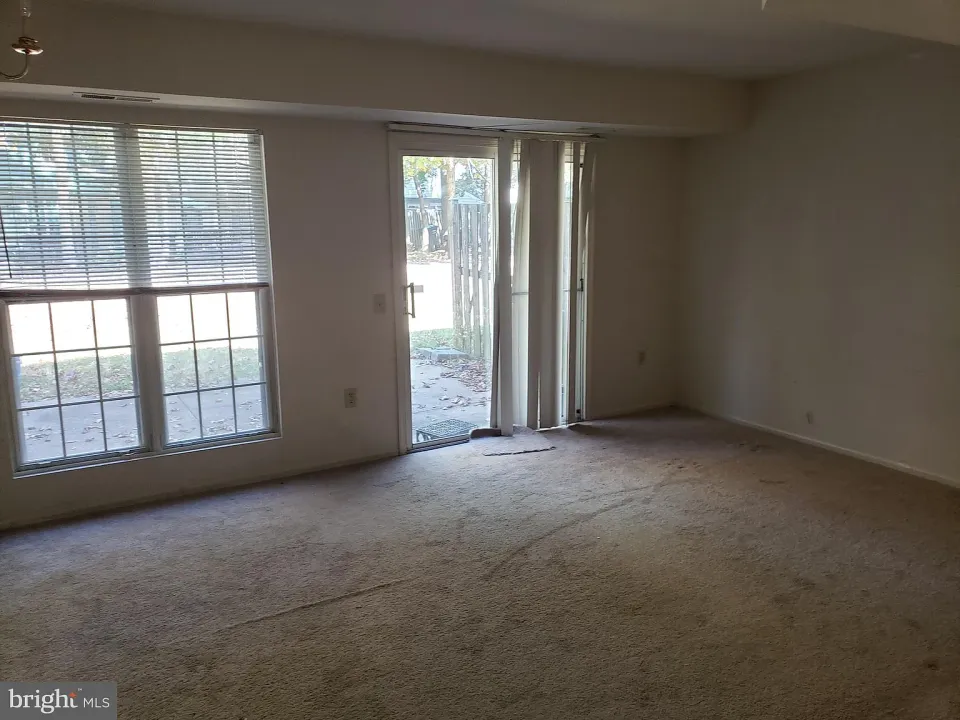 Living room with a large window and sliding glass door