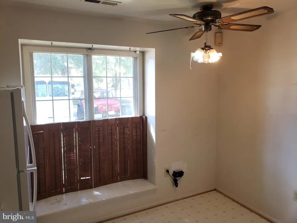 Dining area with a bay window and ceiling fan