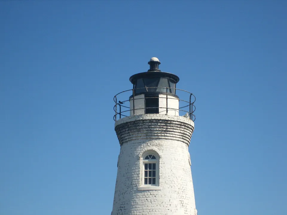 Lighthouse lantern room and railing against a blue sky