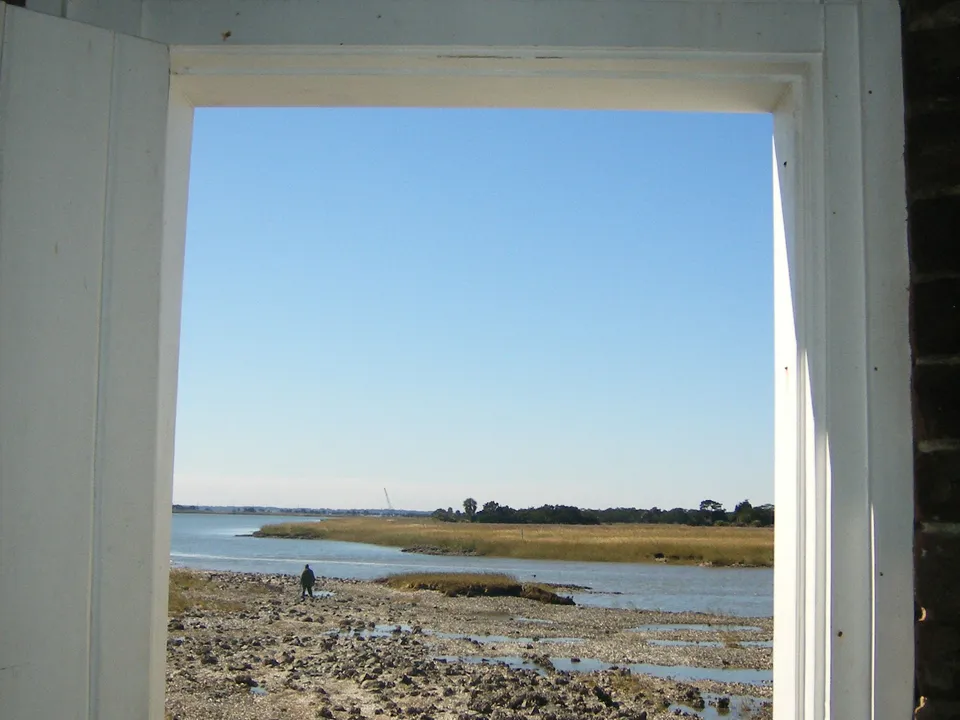 Rocky shoreline and marsh viewed through the lighthouse doorway